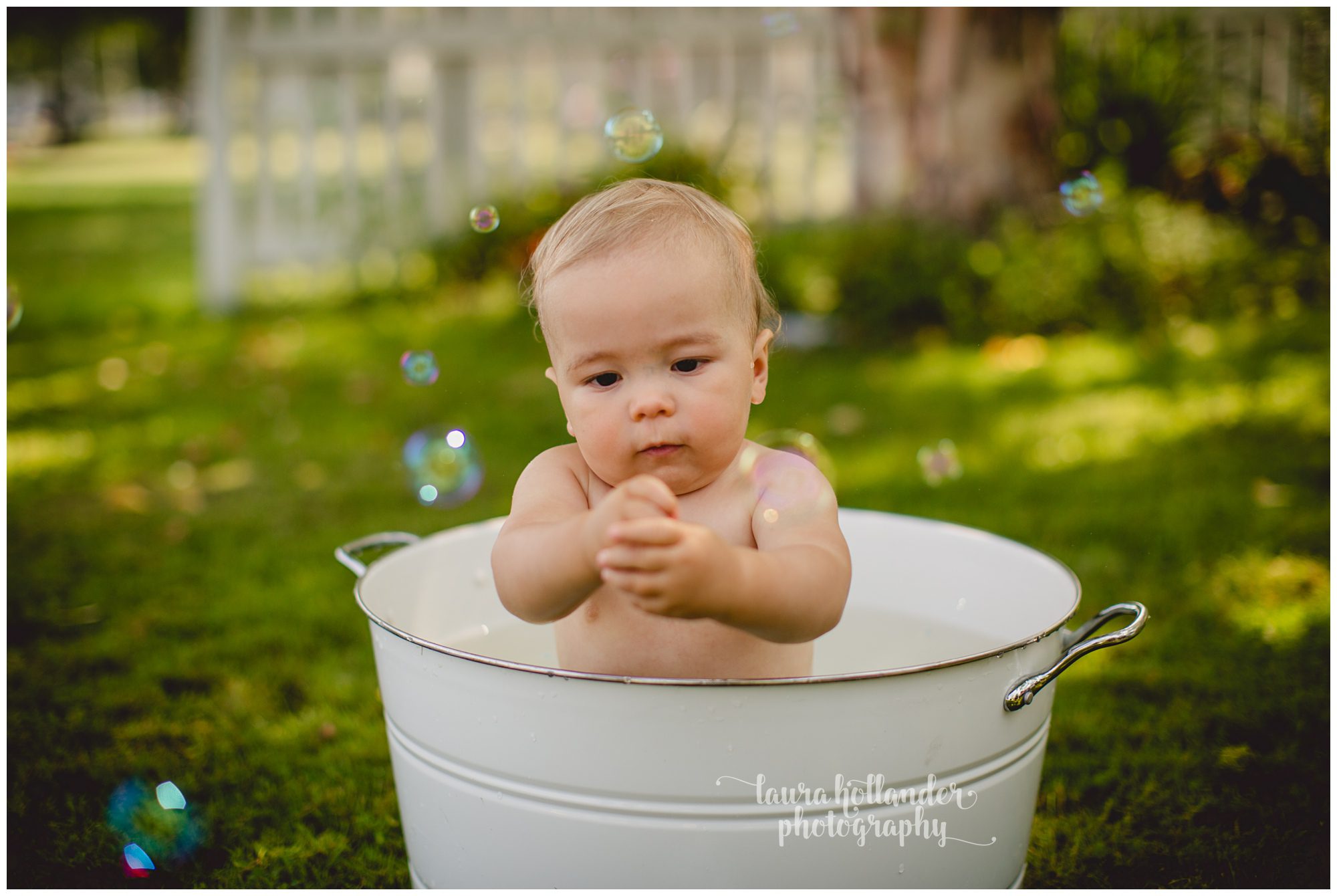 one year milestone, family of three, baby boy in bath bucket with bubbles, outdoor smash cake session