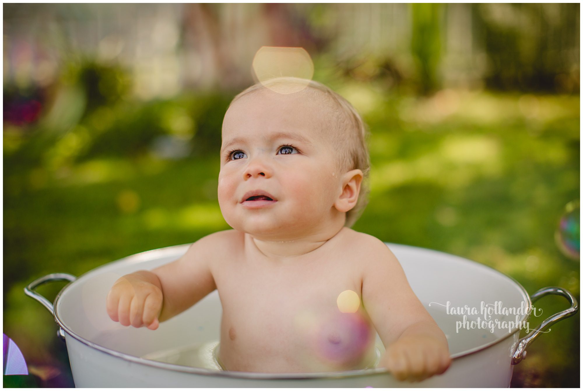 one year milestone, family of three, baby boy in bath bucket with bubbles, outdoor smash cake session