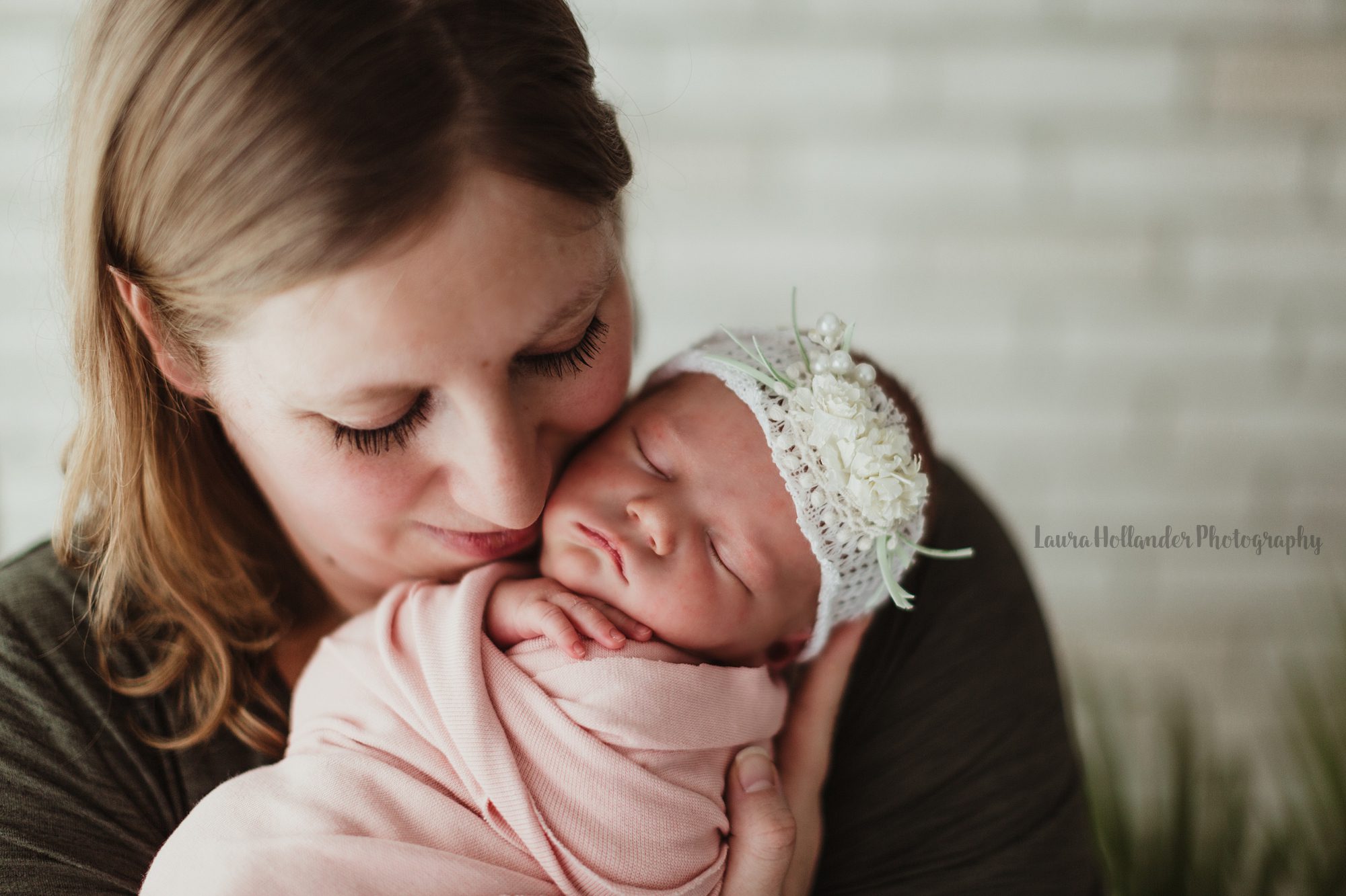mom and newborn baby girl, studio portrait