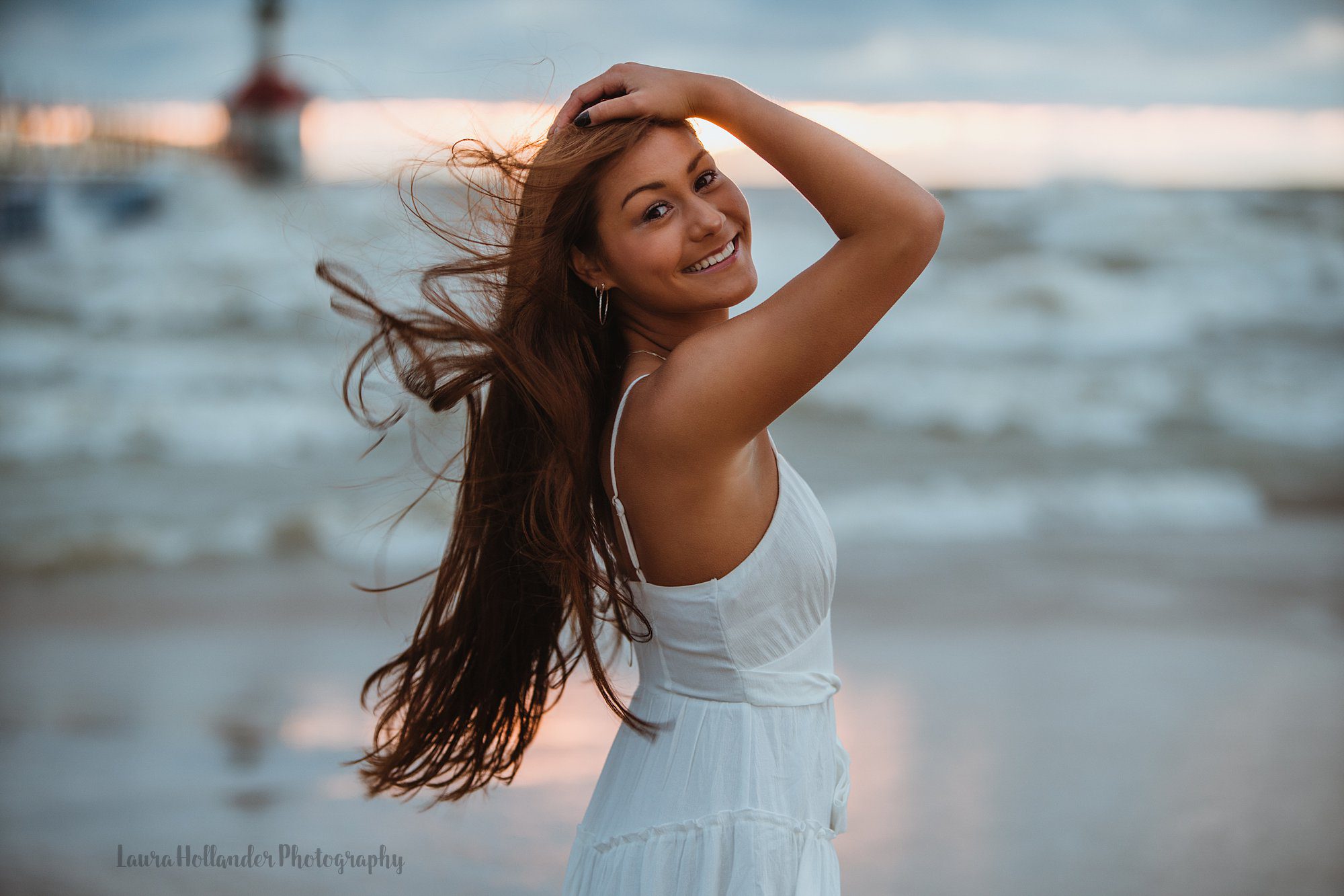 senior beach session in St. Joesph, MI with Laura Hollander Photography, windy beach session at Tiscornia Beach, senior girl with long hair blowing