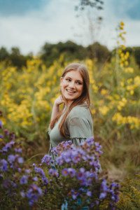 senior portrait in wildflower field